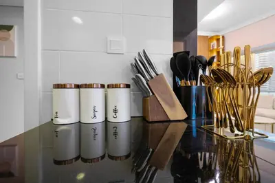 a counter top with a bunch of knives and utensils at Elegant Haven and Spacious 2BR in Lake Terrace in Dubai