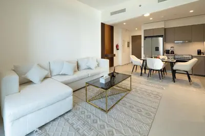 a living room with a white couch and a table at Luxury Grande 2BR Near DubaiMall in Dubai