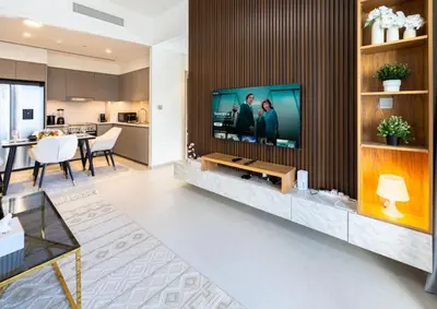 a living room with a flat screen tv on a wall at Luxury Grande 2BR Near DubaiMall in Dubai