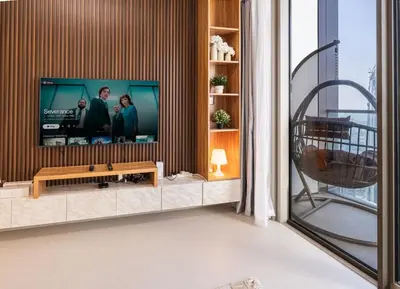 a living room with a flat screen tv on a wall at Luxury Grande 2BR Near DubaiMall in Dubai