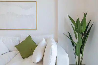 a white couch with pillows in a living room at Luxury 2BR Apartment in Downtown Dubai in Dubai