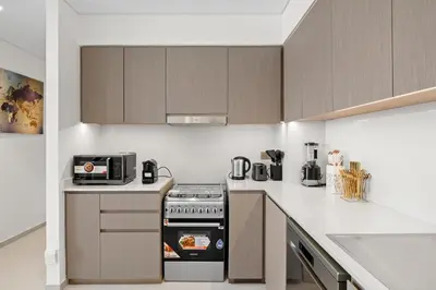 a kitchen with a stove and a microwave at Luxury 2BR Apartment in Downtown Dubai in Dubai