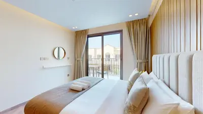 a bedroom with a bed and a large window at Jumeirah Golf Estate - Elegant Three Bed Villa in Dubai