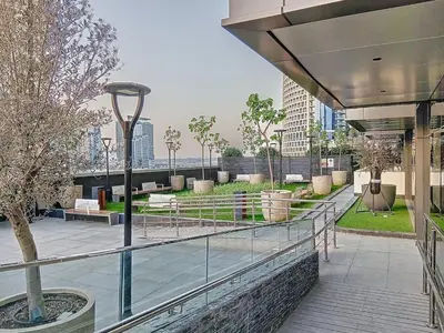 a balcony of a building with a view of a park at Vacationer I Vista 2 Bedroom I Business Bay I Free Parking, Pool, Gym & Wi-Fi in Dubai