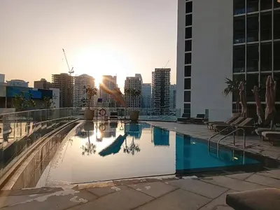 a swimming pool on top of a building with a city at Vacationer I Vista 2 Bedroom I Business Bay I Free Parking, Pool, Gym & Wi-Fi in Dubai