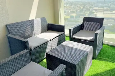 two chairs and a table in a room with a window at Cozy Two Bedroom Apartment in Dubai