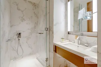 a bathroom with a shower and a sink at Luxury 3BR Apartment with Burj Khalifa Views - Address Opera in Dubai