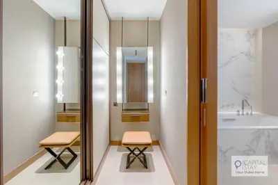 a bathroom with two stools and a sink at Luxury 3BR Apartment with Burj Khalifa Views - Address Opera in Dubai