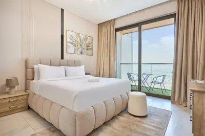 a bedroom with a large bed with a view of the ocean at STAY BY LATINEM Luxury 1BR Holiday Home OPA2401 near Burj Khalifa in Dubai