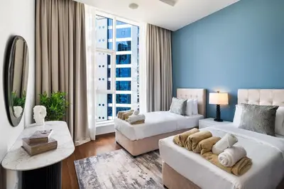 a living room with two beds and a couch at 4BR Oceana Residences - Beach and Pool Access in Dubai