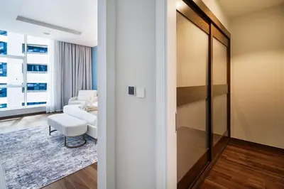 a living room with a couch and a chair at 4BR Oceana Residences - Beach and Pool Access in Dubai