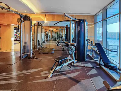 a gym with cardio equipment in a building at 1BD in Ocean Heights, Dubai Marina for 4 Guests in Dubai