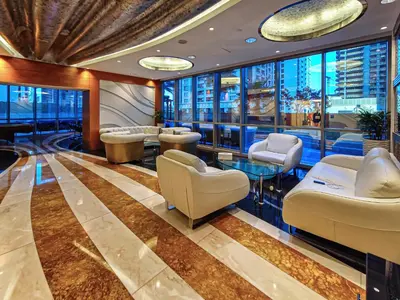 a salon with chairs and tables in a building at 1BD in Ocean Heights, Dubai Marina for 4 Guests in Dubai