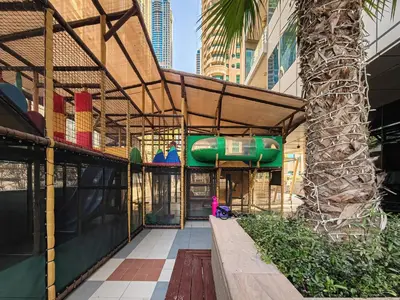 a building with a water slide in the middle at 1BD in Ocean Heights, Dubai Marina for 4 Guests in Dubai