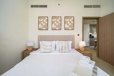 a bedroom with a bed with white sheets and pillows at PVH - Stylish 1BR Near Dubai Mall - Azizi Riviera in Dubai
