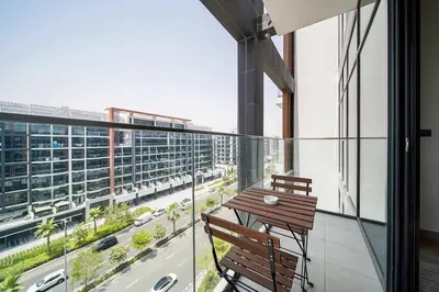 a balcony with two chairs and a table on a building at PVH - Stylish 1BR Near Dubai Mall - Azizi Riviera in Dubai