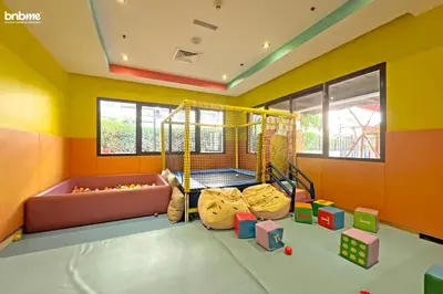 a room with a play room with a swing at bnbme - Luxury Anantara Palm Apt Beachfront Lagoon Pools Balcony & Spa Access in Dubai