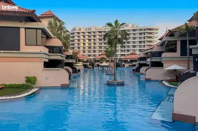 a swimming pool in the middle of a resort at bnbme - Luxury Anantara Palm Apt Beachfront Lagoon Pools Balcony & Spa Access in Dubai