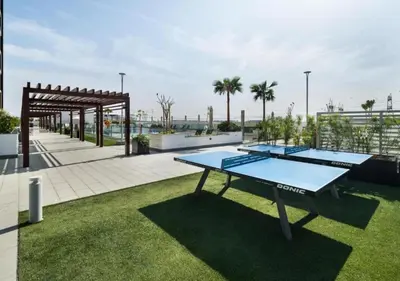 two ping pong tables on the roof of a building at Bespoke Holiday Homes - Studio with Modern Amenities in Azizi Riviera in Dubai