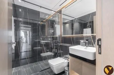 a bathroom with a white toilet and a sink at Vogue JVC Binghatti Corner near Circle Mall, Two Bedroom Apartment with Balcony and City View, Access to all Amenities in Dubai
