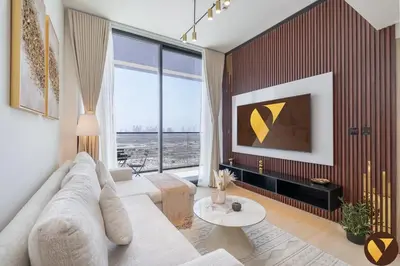 a living room with a couch and a large window at Vogue JVC Binghatti Corner near Circle Mall, One Bedroom Apartment with Balcony and City View, Access to all Amenities in Dubai