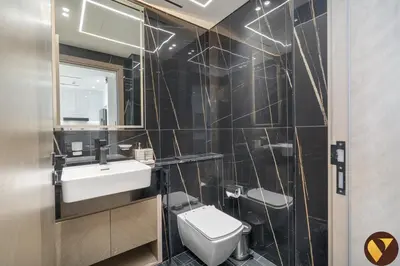 a bathroom with a toilet and a sink and a mirror at Vogue JVC Binghatti Corner near Circle Mall, One Bedroom Apartment with Balcony and City View, Access to all Amenities in Dubai