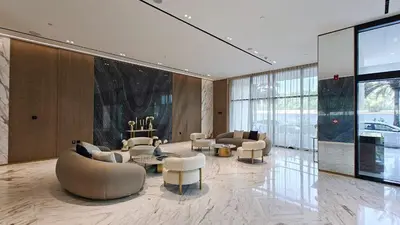 a large lobby with couches and tables and chairs at Vogue JVC Binghatti Corner near Circle Mall, One Bedroom Apartment with Balcony and City View, Access to all Amenities in Dubai