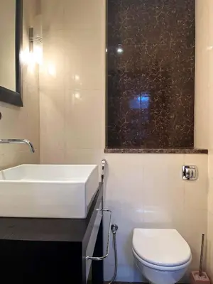 a bathroom with a white sink and a toilet at Luxury 2BR with Contemporary Design & Great Views in Dubai