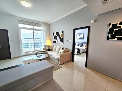 a living room with a couch and a table at SUNRISE HOMES - Charming 1-BR Just a walk to JBR Beach in Dubai