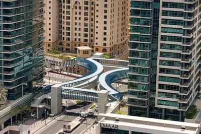 a curved road in a city with tall buildings at High-Floor Marina View - Balcony, Pool and Gym in Dubai