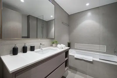 a bathroom with a sink and a bath tub at Luxury 2BR Burj Fountain View Walk to Dubai Mall in Dubai