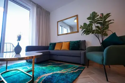 a living room with a couch and a table and a mirror at Modern 1BR 4 Guests Dubai World Trade Center in Dubai