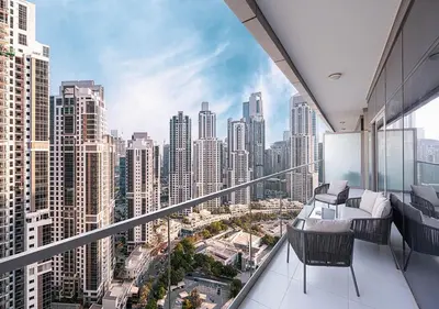 an apartment balcony with a view of a city at Paramount Midtown Hotel - Luxury Apartments & Infinity Pool with Burj Khalifa View in Dubai