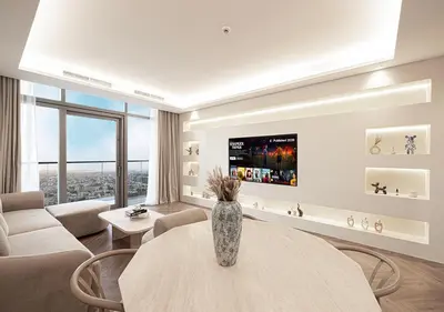 a living room with a vase on a table at Paramount Midtown Hotel - Luxury Apartments & Infinity Pool with Burj Khalifa View in Dubai