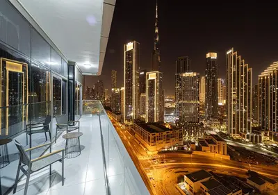 a view of a city at night from a building at Paramount Midtown Hotel - Luxury Apartments & Infinity Pool with Burj Khalifa View in Dubai
