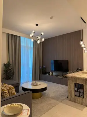 a living room with a couch and a table at Stylish 2BR - Burj Khalifa - Waterfront View - Fully Furnished in Dubai