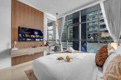 a bedroom with a white bed and a large window at Serene Palm Studio - Rooftop Infinity Pool & Private Beach Access in Dubai
