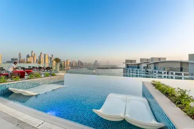 a swimming pool on the roof of a building at Serene Palm Studio - Rooftop Infinity Pool & Private Beach Access in Dubai
