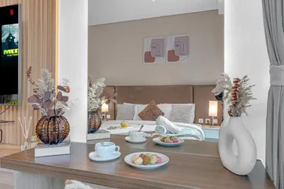 a living room with a table with plates of food at Serene Palm Studio - Rooftop Infinity Pool & Private Beach Access in Dubai