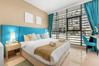 a bedroom with a large bed and a large window at Stunning Palm Studio - Rooftop Infinity Pool & Private Beach Access - MaxStays in Dubai