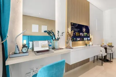 a room with a desk with a laptop and chairs at Stunning Palm Studio - Rooftop Infinity Pool & Private Beach Access - MaxStays in Dubai