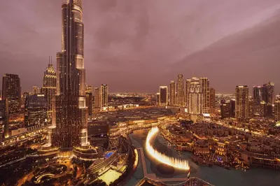 a view of a city at night at Luxury 2BR Burj View Private Hot Tub Walk to DubaiMall in Dubai