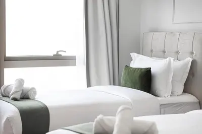 a hotel room with two beds and a window at Luxury 2BR Burj View Private Hot Tub Walk to DubaiMall in Dubai