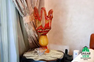 a glass vase sitting on top of a table at Souk AL Bahar Burj Khalifa View from main door, luxury Apartment, Dream view holiday homes in Dubai