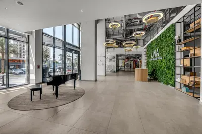 a lobby with a grand piano in a building at Waves - Stylish Blue Haven near Town Square Park in Dubai