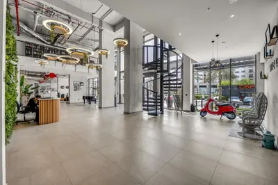 an empty lobby with a scooter in a building at Waves - Stylish Blue Haven near Town Square Park in Dubai