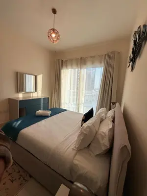 a bedroom with a large bed and a window at Stunning Park View 1Bhk 4pax in Dubai