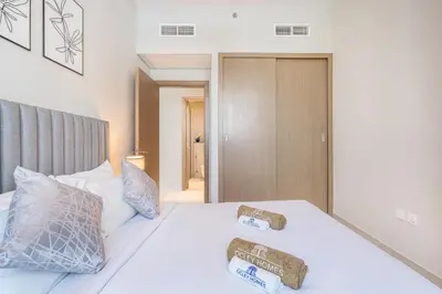 a bedroom with a white bed with two boxes on it at Modern Family Home with Dubai Skyline Views in Dubai