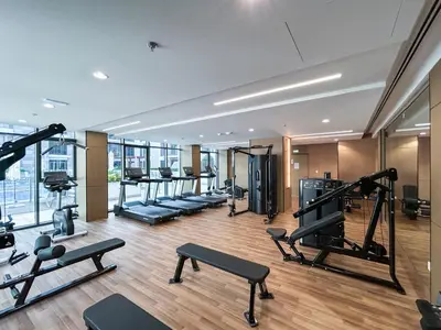 a gym with treadmills and machines in a building at Modern Family Home with Dubai Skyline Views in Dubai
