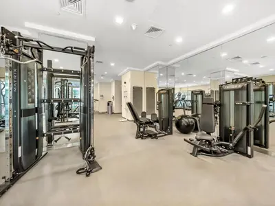 a gym with several treadmills and machines at The Fountain Views Suite in Downtown Dubai in Dubai